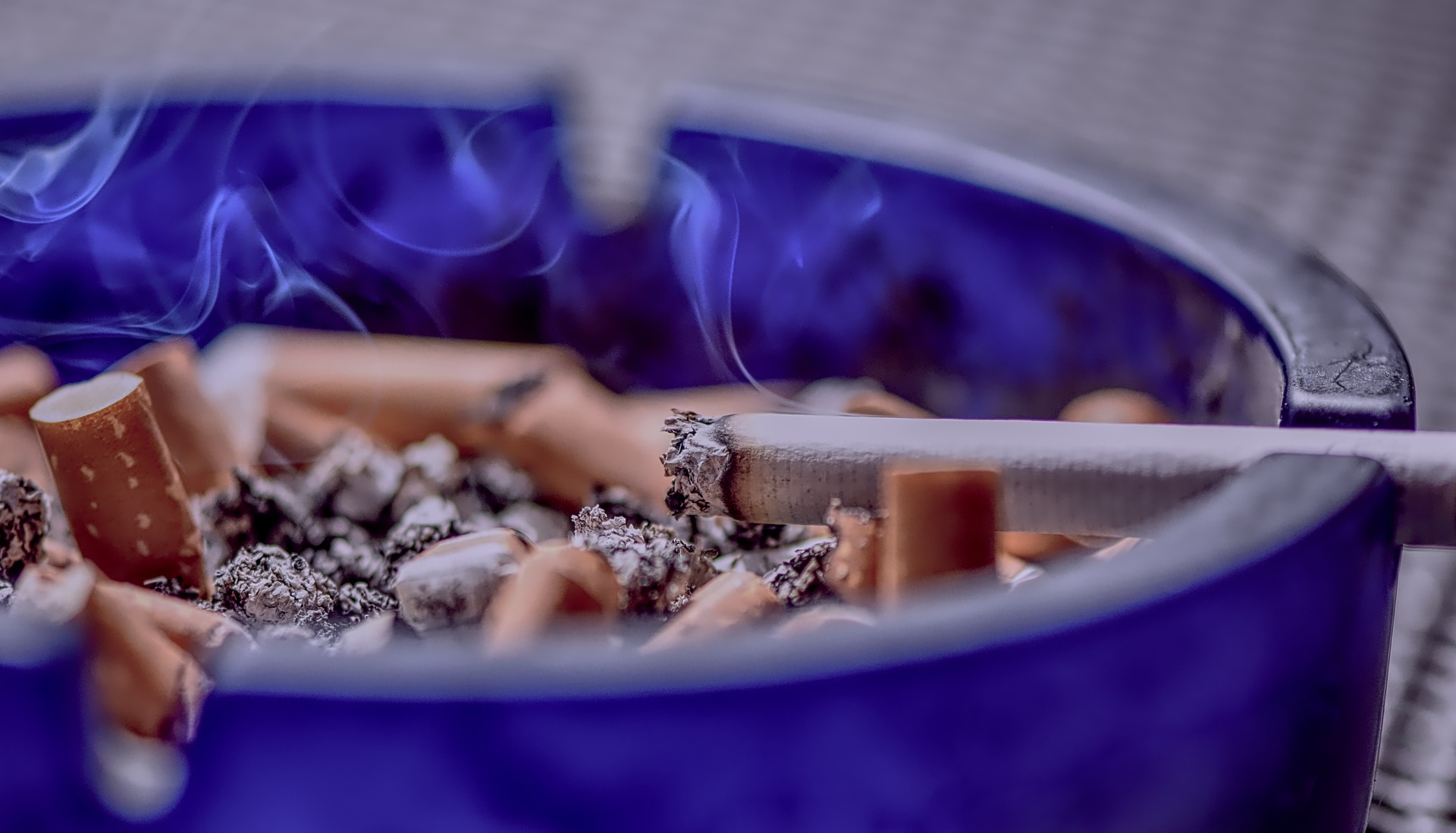 burning cigarettes in ash tray